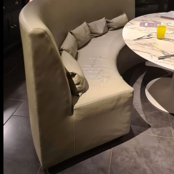 beige banquette in need or reupholstery