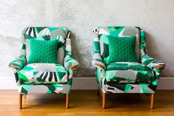 Pair of chairs with wooden legs covered in Kitty McCall Rousseau fabric