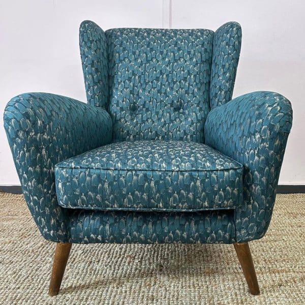 mid century chair with blue fabric and wooden legs in need of reupholstery