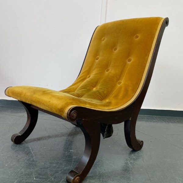 Small chair with dark wood and stained mustard velvet awaiting reupholstery