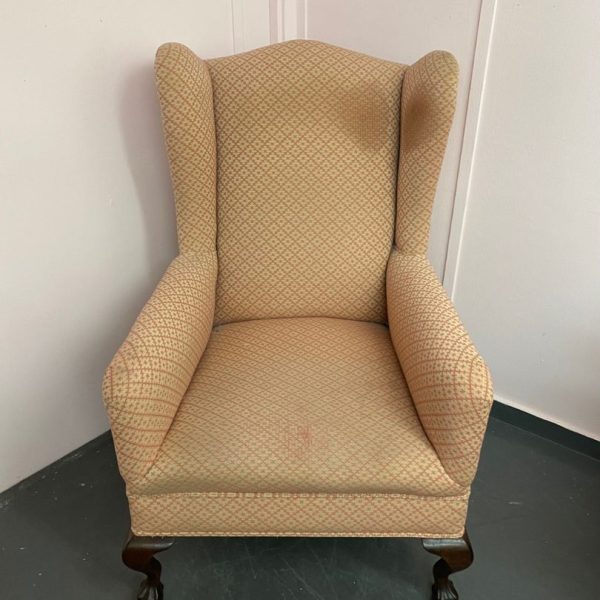 stained wing backed chair in need of reupholstery