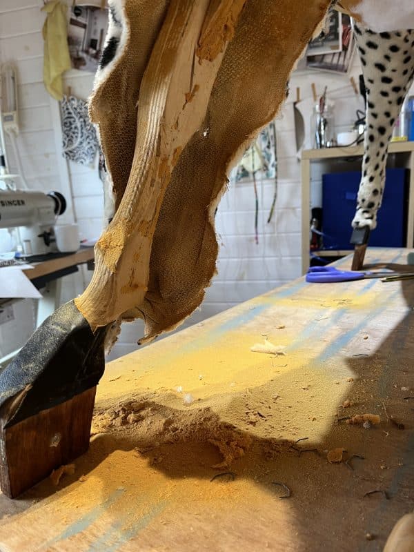 Photo of leg of rocking horse being restored