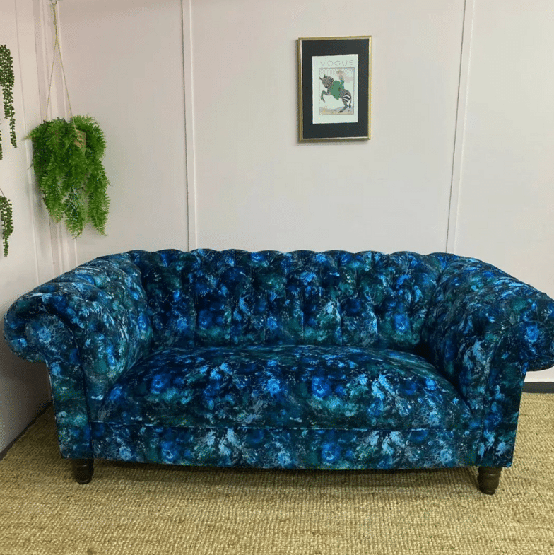 A blue sofa reupholstered by an expert