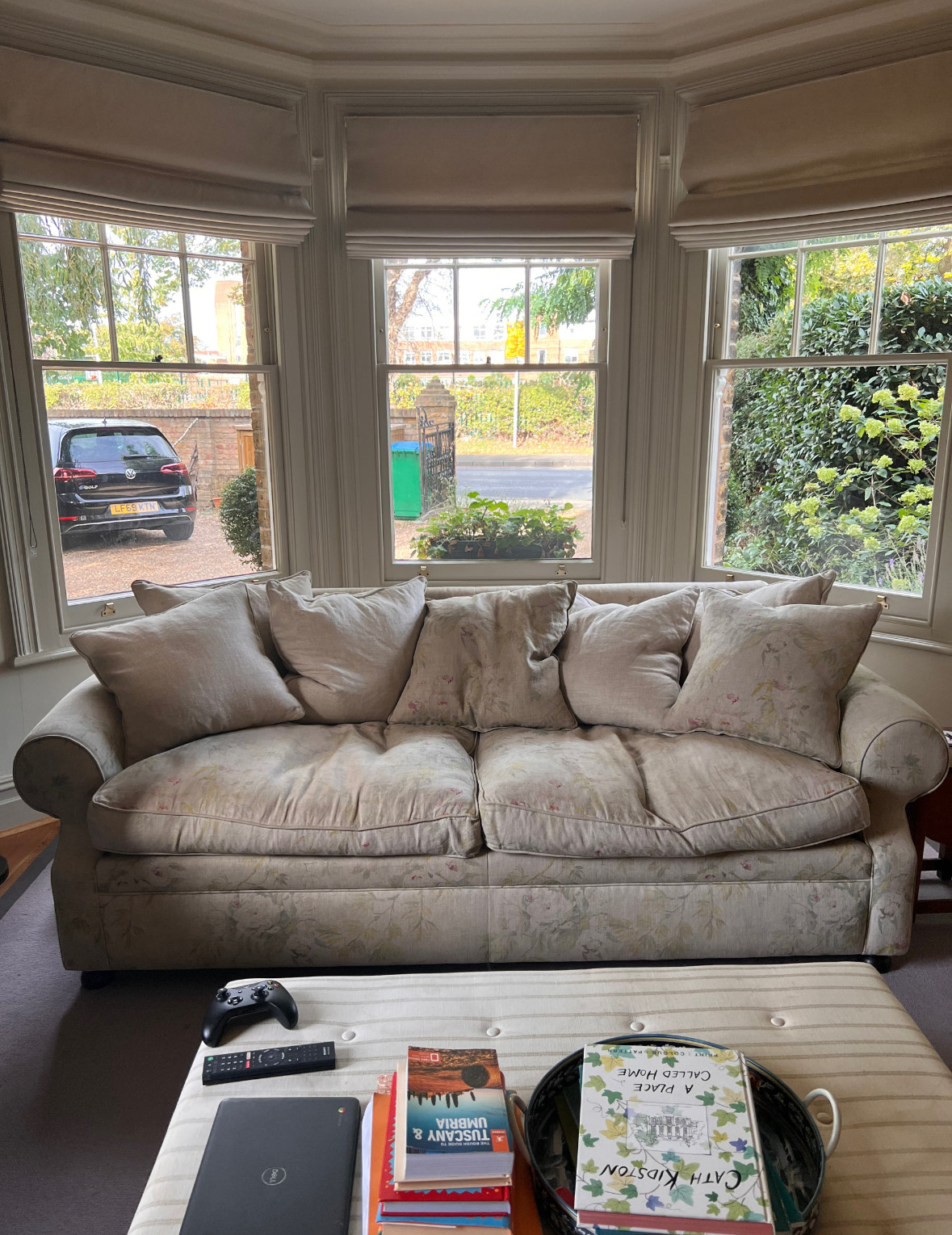An old sofa that is faded due to being exposed to too much UV light 