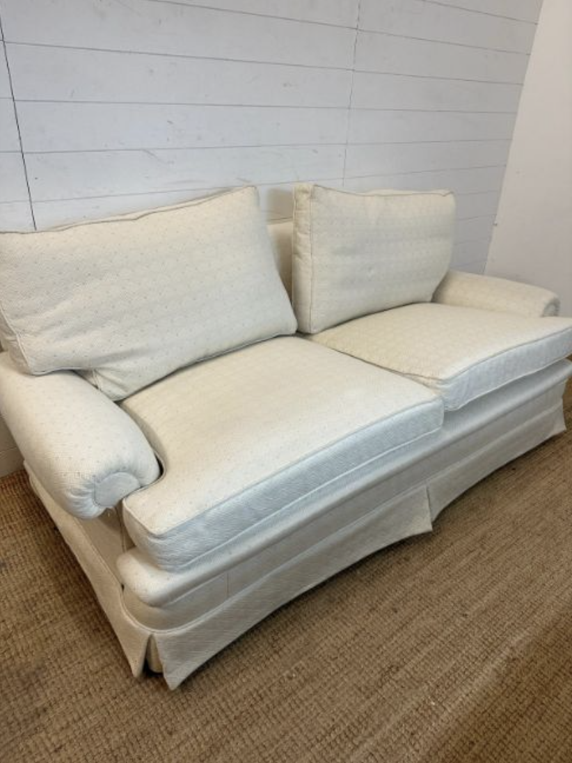 A white three-seater sofa