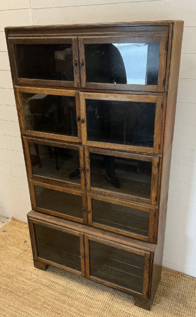 An English oak sectional bookcase in two parts sold at Windsor Auctions