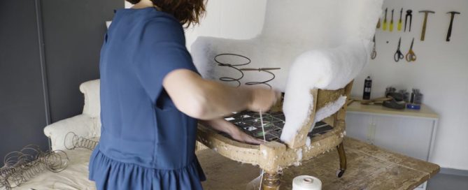 Sharon adding upholstery springs into a chair