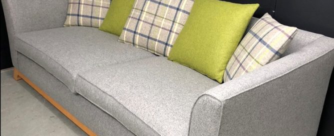 Reupholstered sofa in grey with patterned scatter cushions