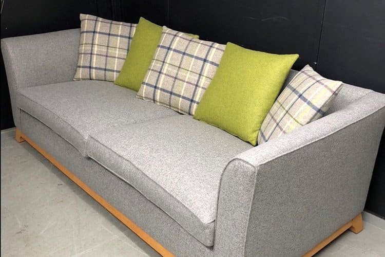 Reupholstered sofa in grey with patterned scatter cushions
