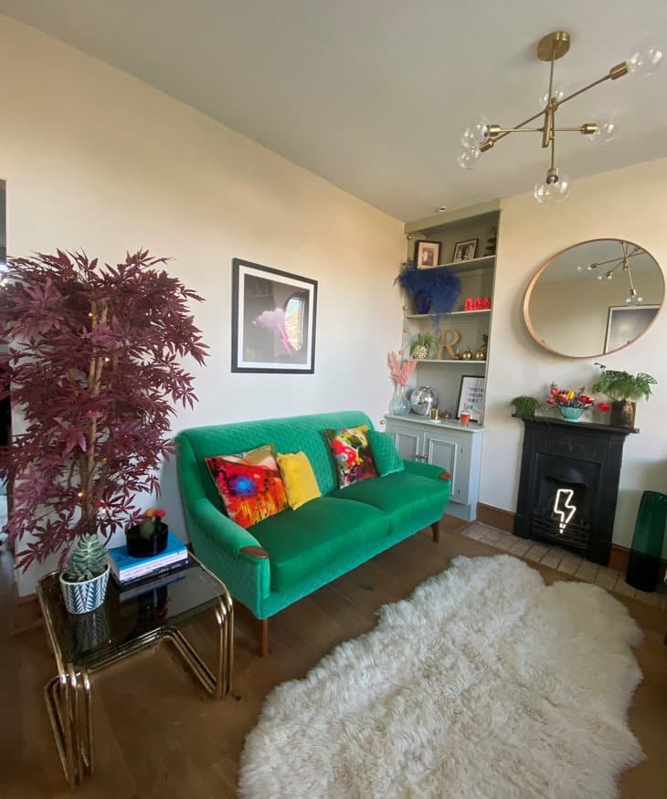 Mid century sofa reupholstered in a green fabric in a sitting room