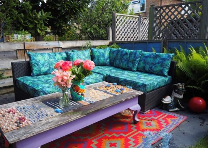 Outdoor sofa with blue and green pattern cushions