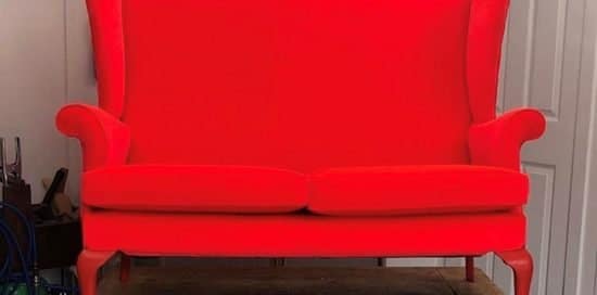 Reupholstered Parker Knoll sofa in neon red fabric
