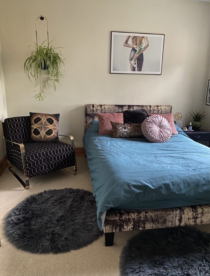 Armchair and bed with reupholstered cushions in bedroom