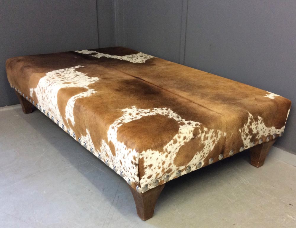Cow Hide foot stool with wooden legs after upholstery