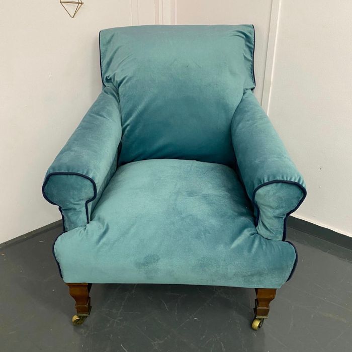 19th Century Cornelius V Smith armchair with blue velvet material, wooden legs and castors
