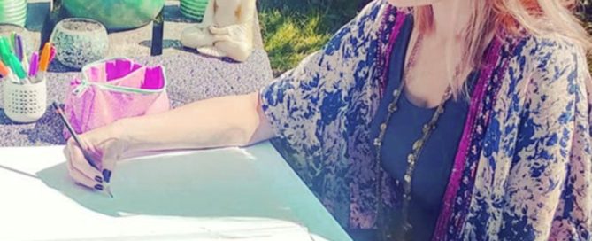Becca Who sketching designs outside