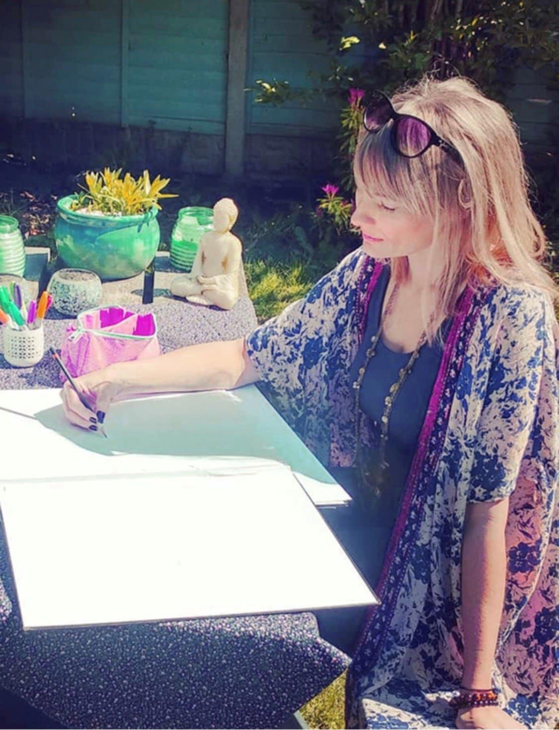 Becca Who sketching designs outside