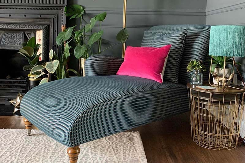 chaise longue in dark pattern fabric with pink cushion