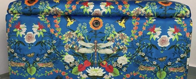 an upholstered ottoman with a flowery themed pattern