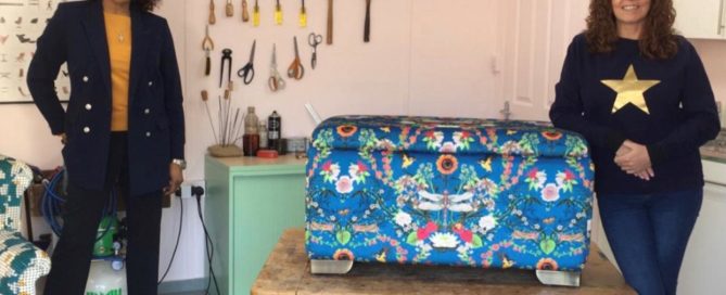 Sharon O' Connor stand with presenter Jacqui Joseph in front of the finished ottoman covered in a blue patterned fabric