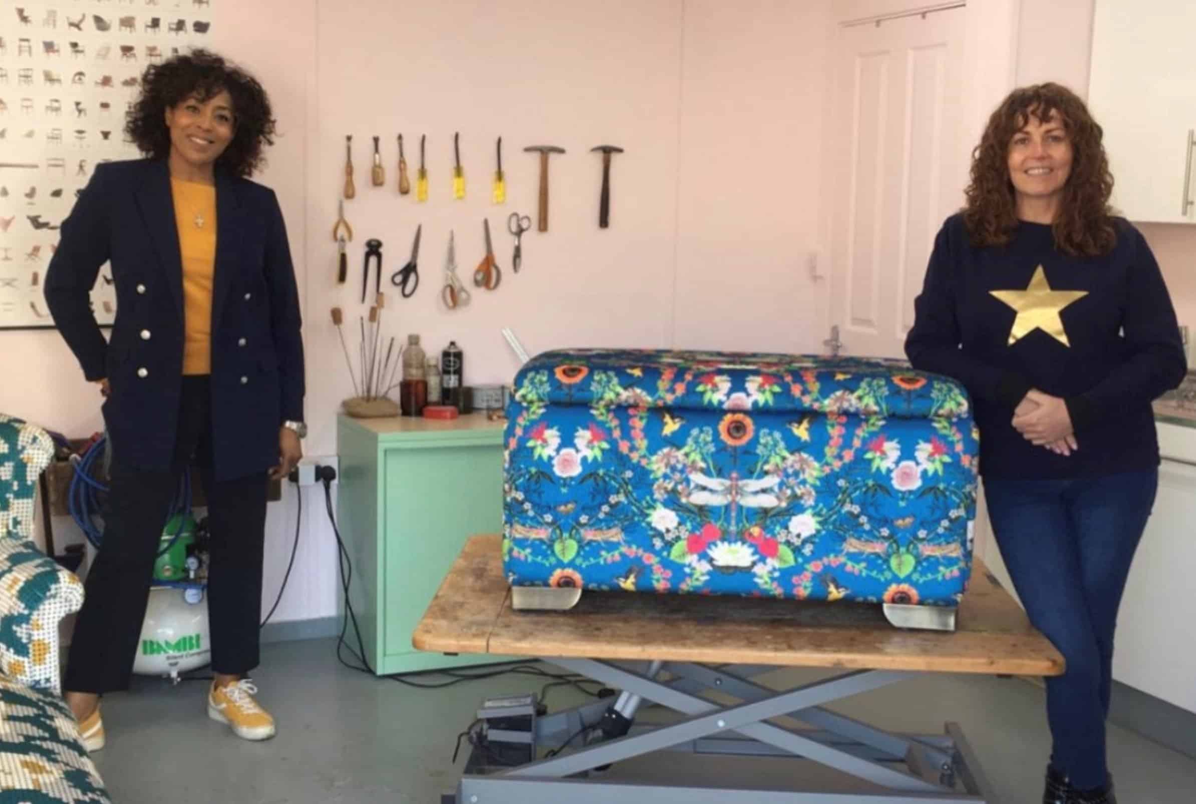 Sharon O' Connor stand with presenter Jacqui Joseph in front of the finished ottoman covered in a blue patterned fabric