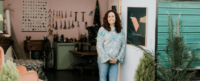 External shot of the Vintique Upholstery workshop, Sharon O Connor standing by an open door