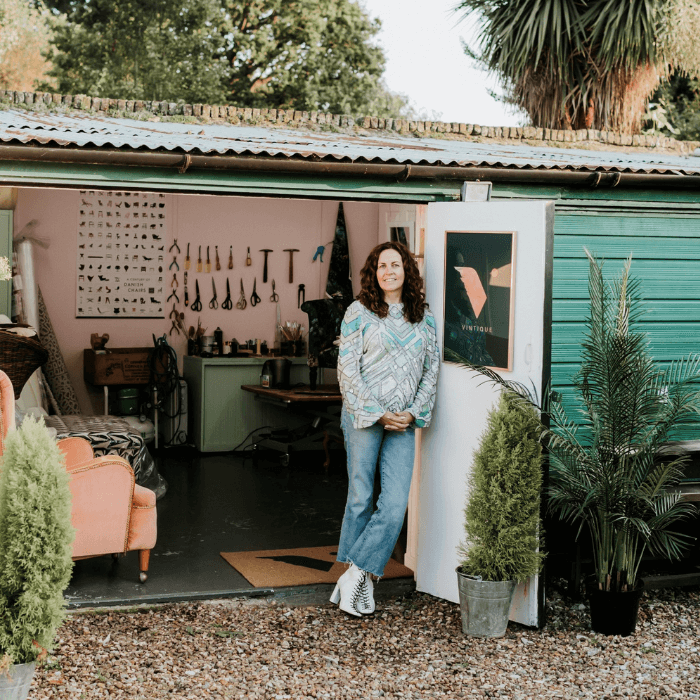 External shot of the Vintique Upholstery workshop, Sharon O Connor standing by an open door
