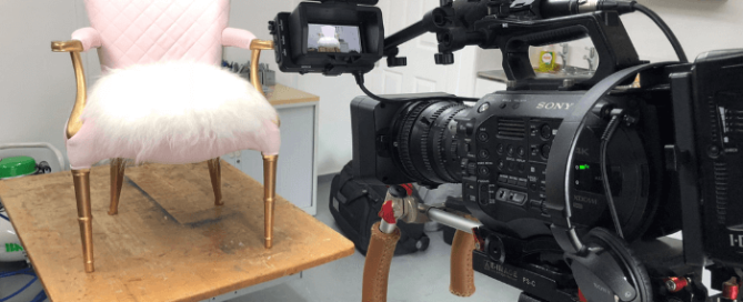 The Vintique Upholstery workshop during filming of BBC Money For Nothing show showing a camera filming an armchair with gold painted legs covered in pink fabrics