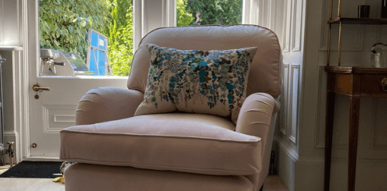 Client's finished upholstery transformation, now a light pink velvet chair