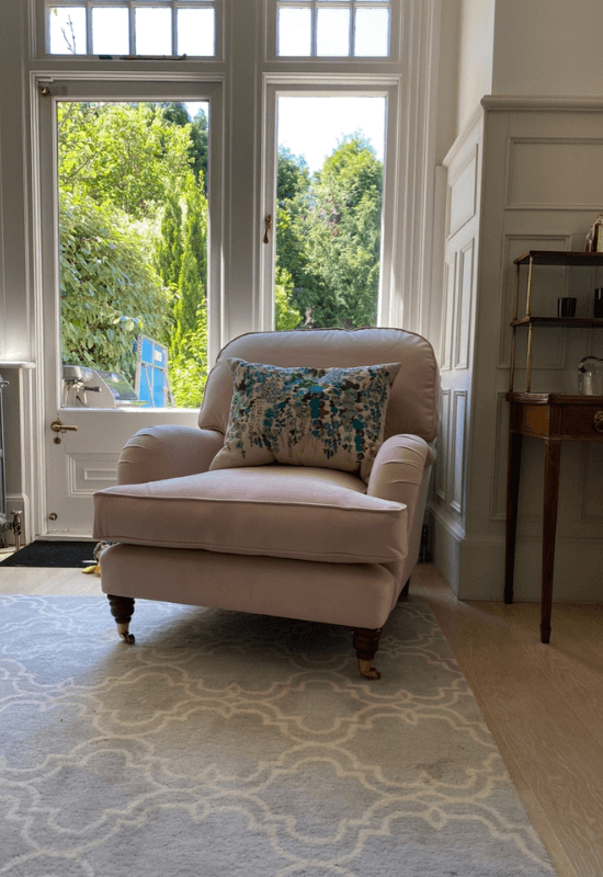 Client's finished upholstery transformation, now a light pink velvet chair