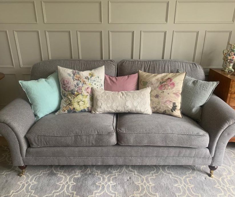 Grey subtle pattern sofa with scatter cushions.