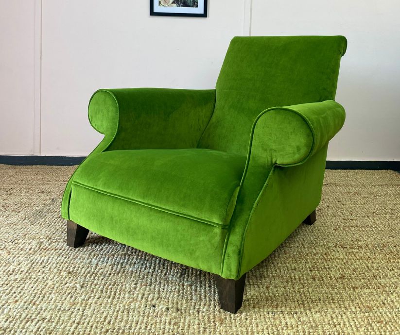Reupholstered armchair in green velvet with dark wood feet